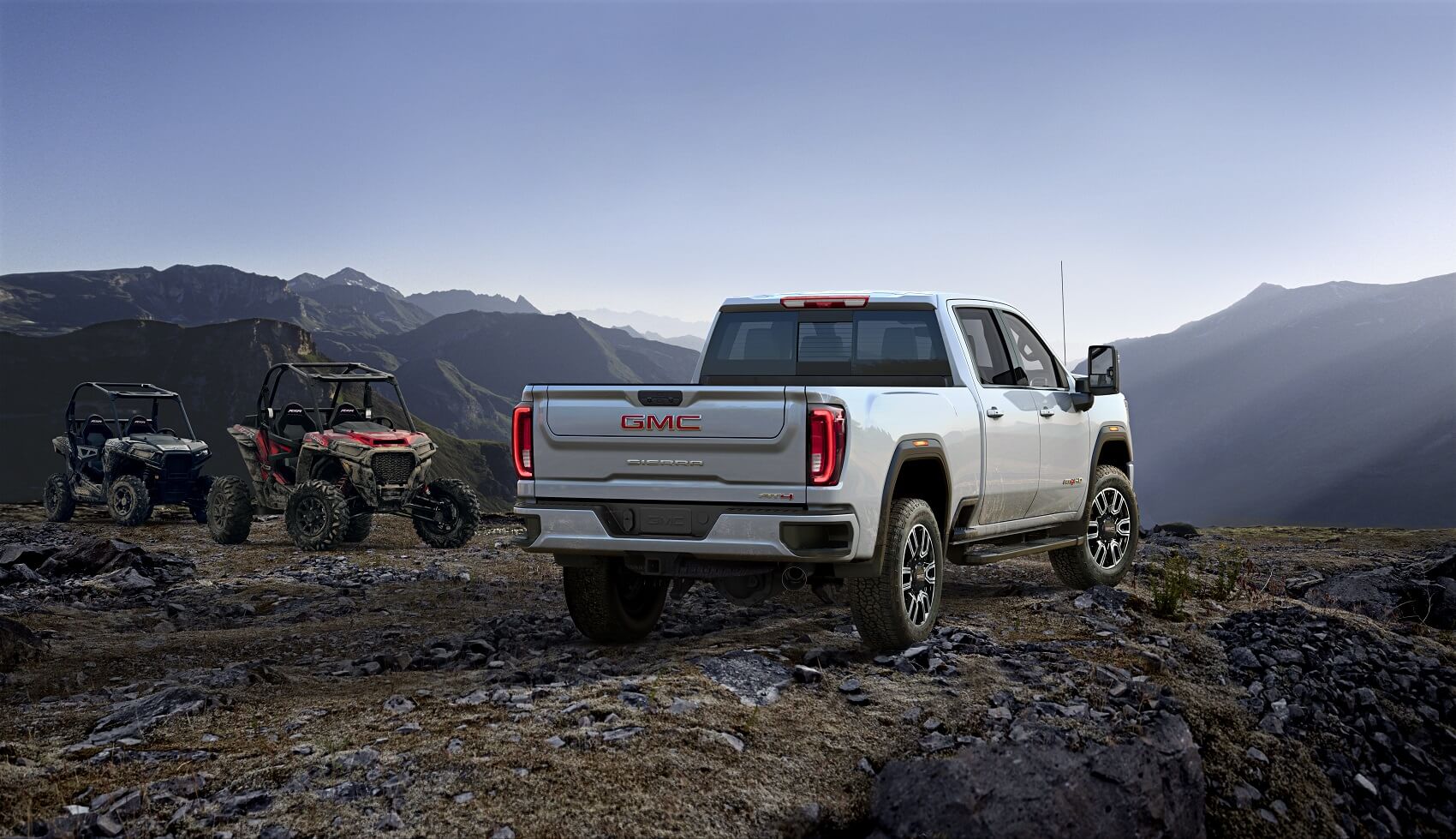Back view of GMC Sierra 2500 parked on a mountain cliff from Used Car Dealer Near Santee CA