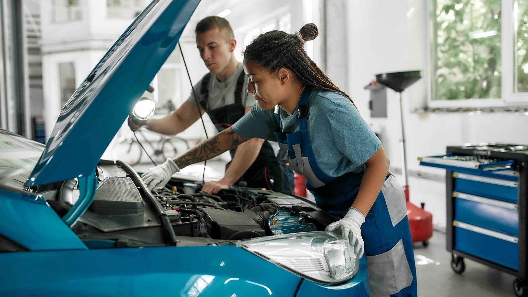 Ford service tech inspecting vehicle engine