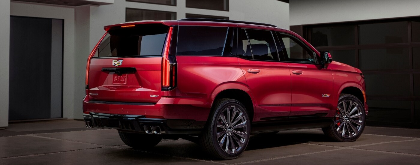 A red 2025 Cadillac Escalade for sale near Miami Beach from the rear.