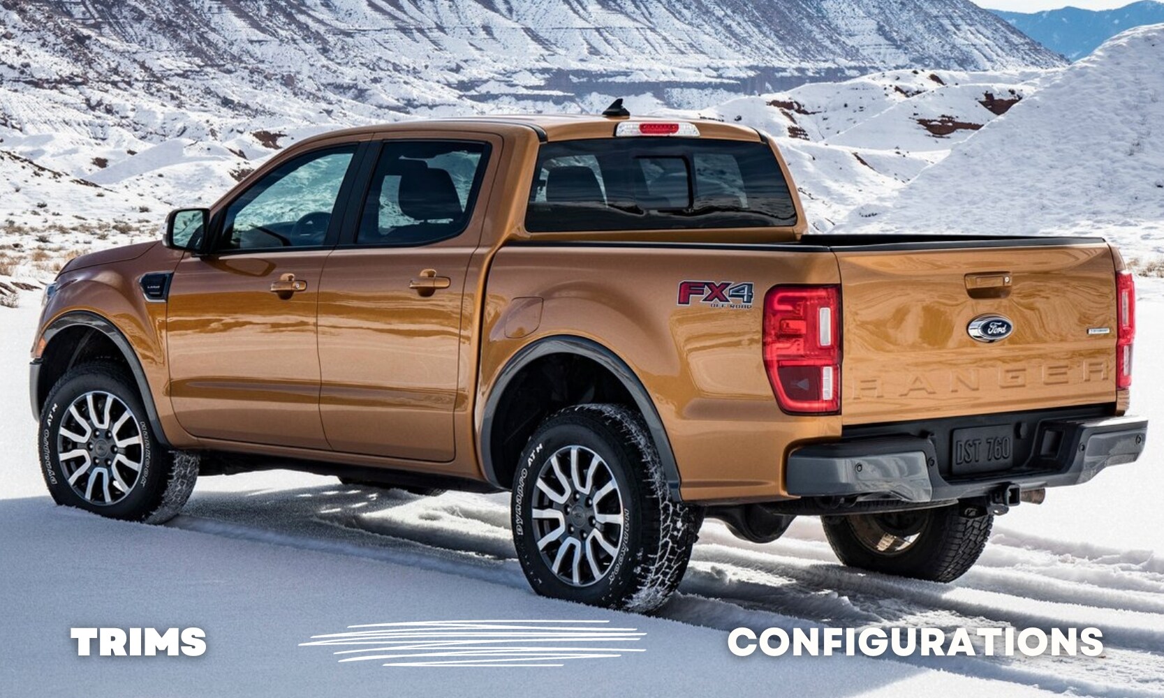 Rear view of an orange used Ford Ranger FX4 Lariat parked in some snow up in the mountains