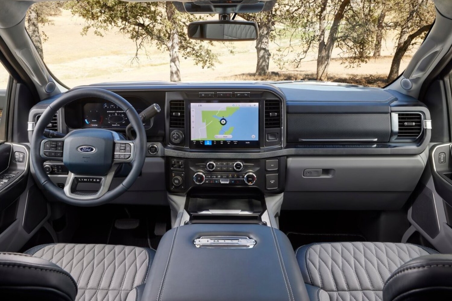 New 2023 Ford Super Duty Interior Comparison - Octane GMC of Santa Fe.jpg Front interior dashboard inside the 2023 Ford F-250 Super Duty Limited as seen from the rear seats