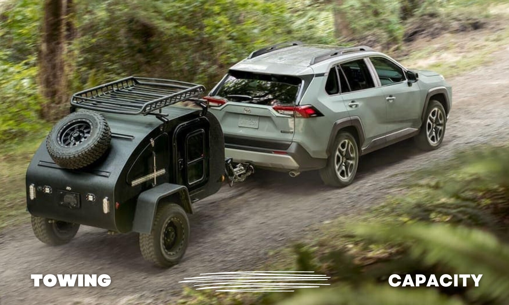  a green used Toyota RAV4 SUV driving down a dirt road pulling a small camper