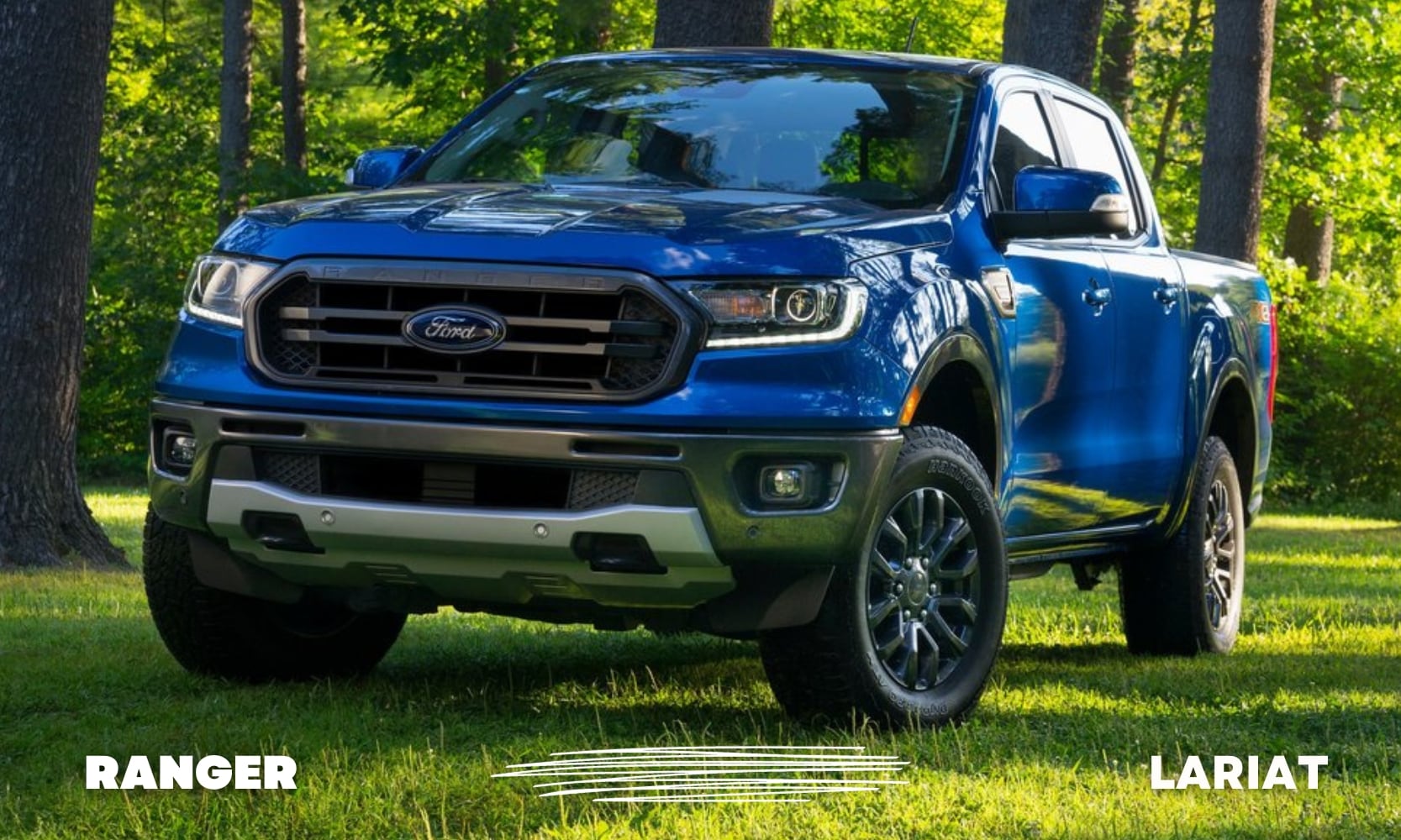 Front profile view of a blue Ford Ranger Lariat truck parked on some beautiful green grass in a forest clearing