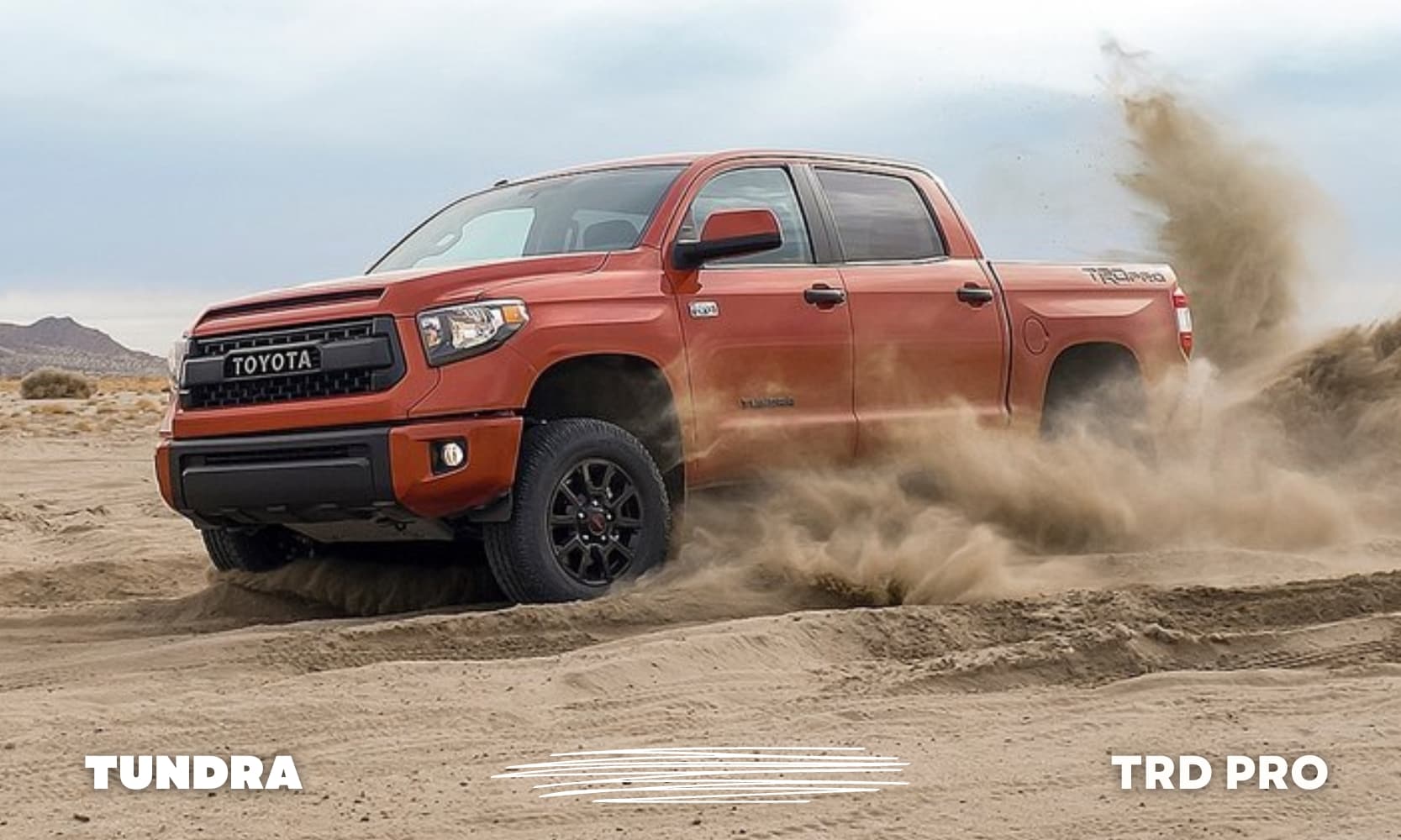 an orange used Toyota Tundra TRD Pro driving off-road through sand dunes