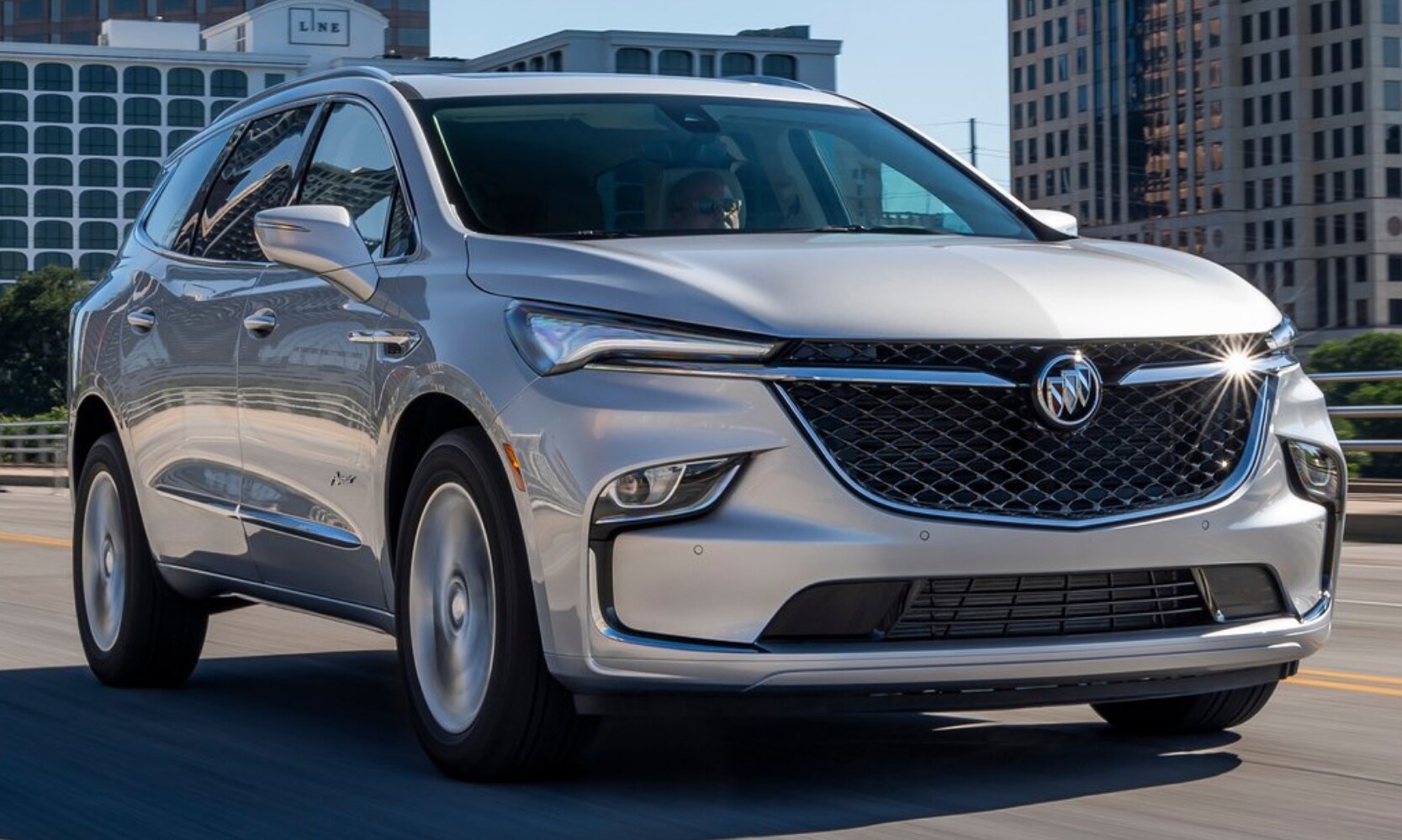 2022 Buick Enclave Performance Comparison - Octane Buick GMC of Santa Fe.png New 2022 Buick Enclave in silver color driving down an open highway