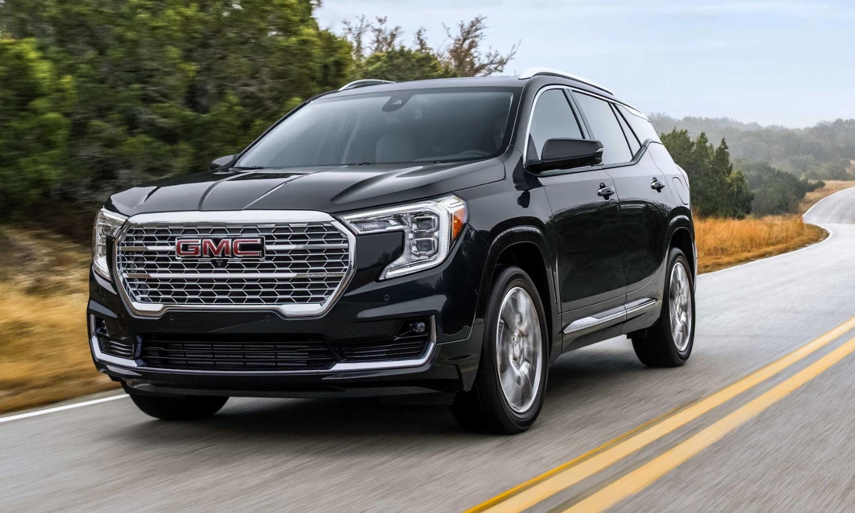 2023 GMC Terrain Denali driving fast down an open road