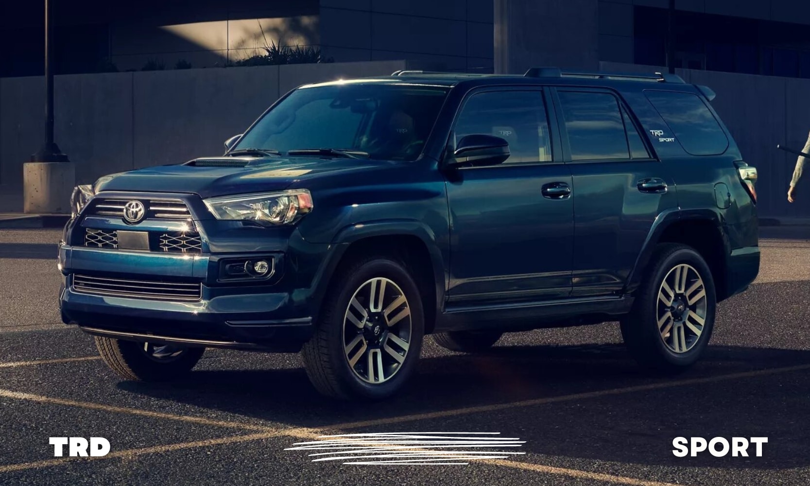a blue used Toyota 4Runner TRD Sport SUV parked in a parking lot outside a gym