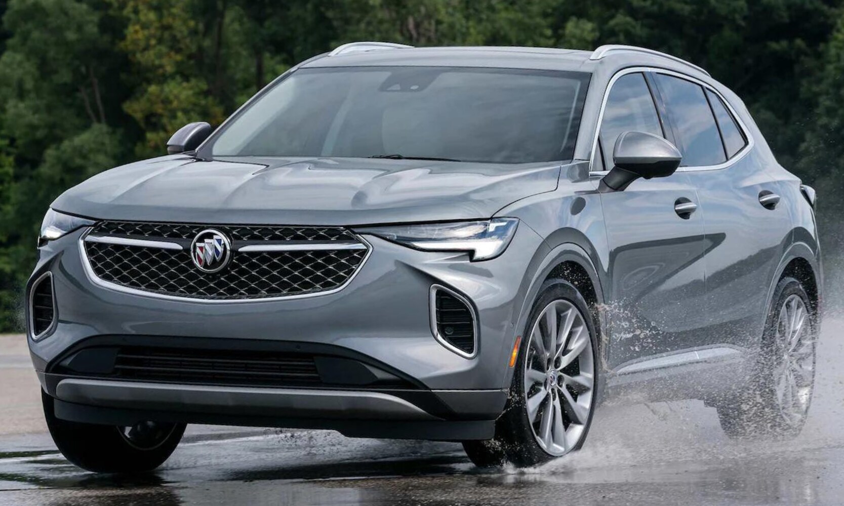 2022 Buick Envision Performance Comparison - Octane Buick GMC of Santa Fe.png New 2022 Buick Envision driving in the rain taking a hard left turn