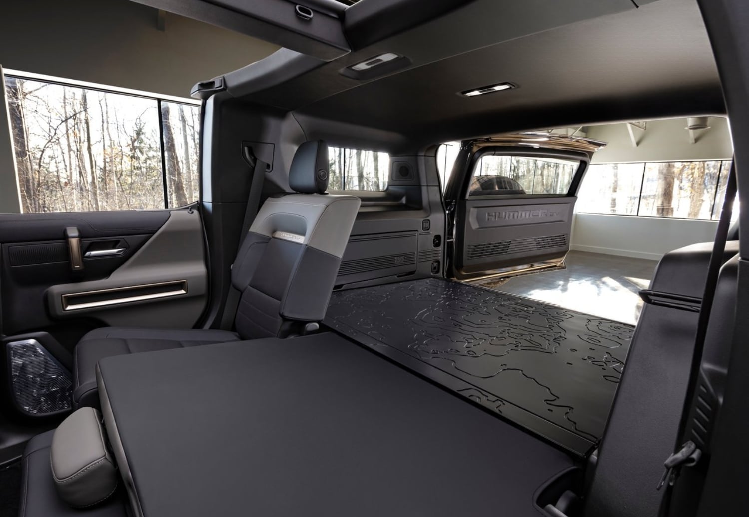 2024 GMC Hummer EV SUV Cargo Space Comparison showing the rear cargo area with seats folded down