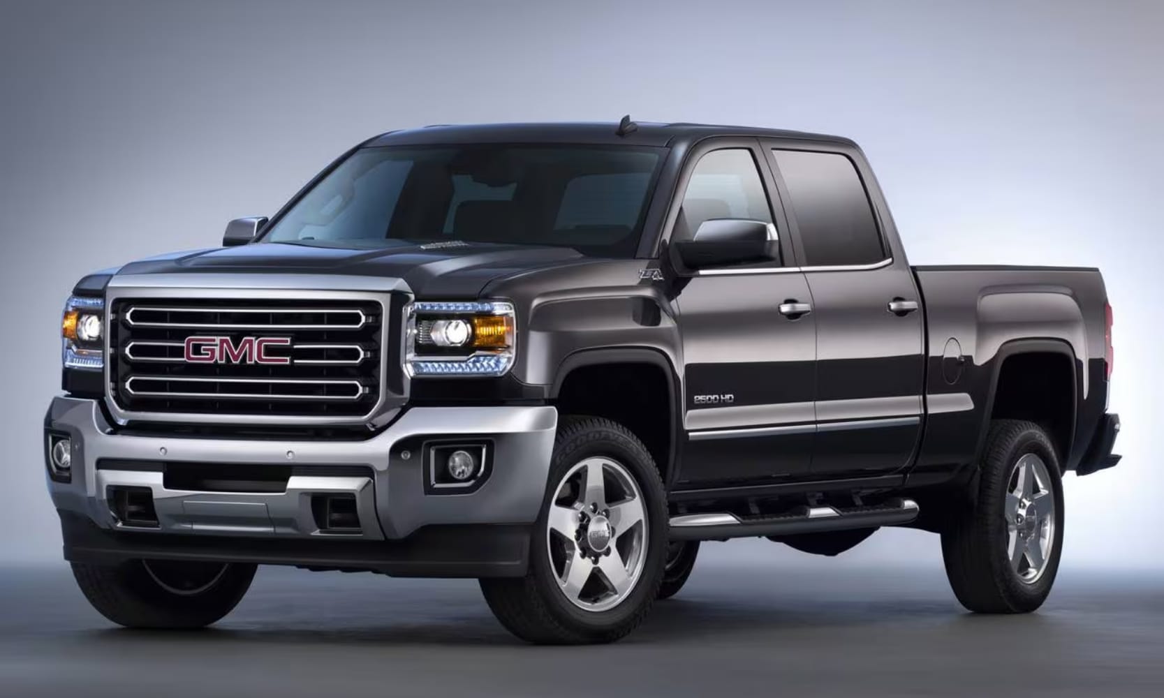 photo of a black 2015 GMC Sierra 2500 HD SLT Truck in a gray room