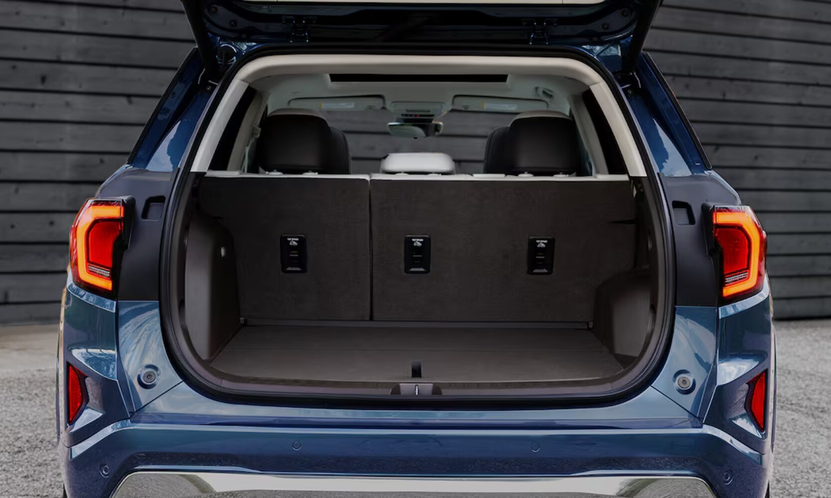 2026 GMC Terrain Cargo - Octane GMC of Santa Fe.jpg Exterior rear image of a blue 2026 GMC Terrain with an open trunk showing the cargo space