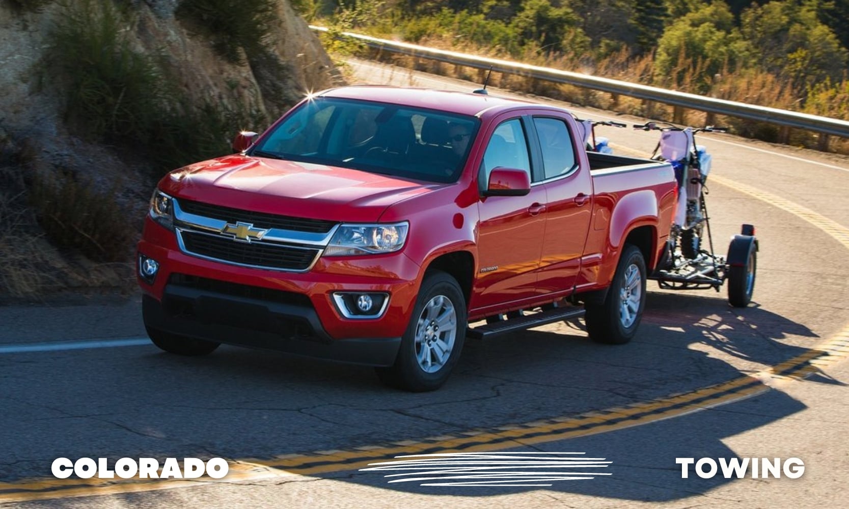 Best%20Used%20Chevy%20Colorado%20Trucks%20for%20Towing%20-%20Octane%20GMC%20of%20Santa%20Fe.jpg a red Chevy Colorado truck towing two dirt bikes around a curvy mountain road