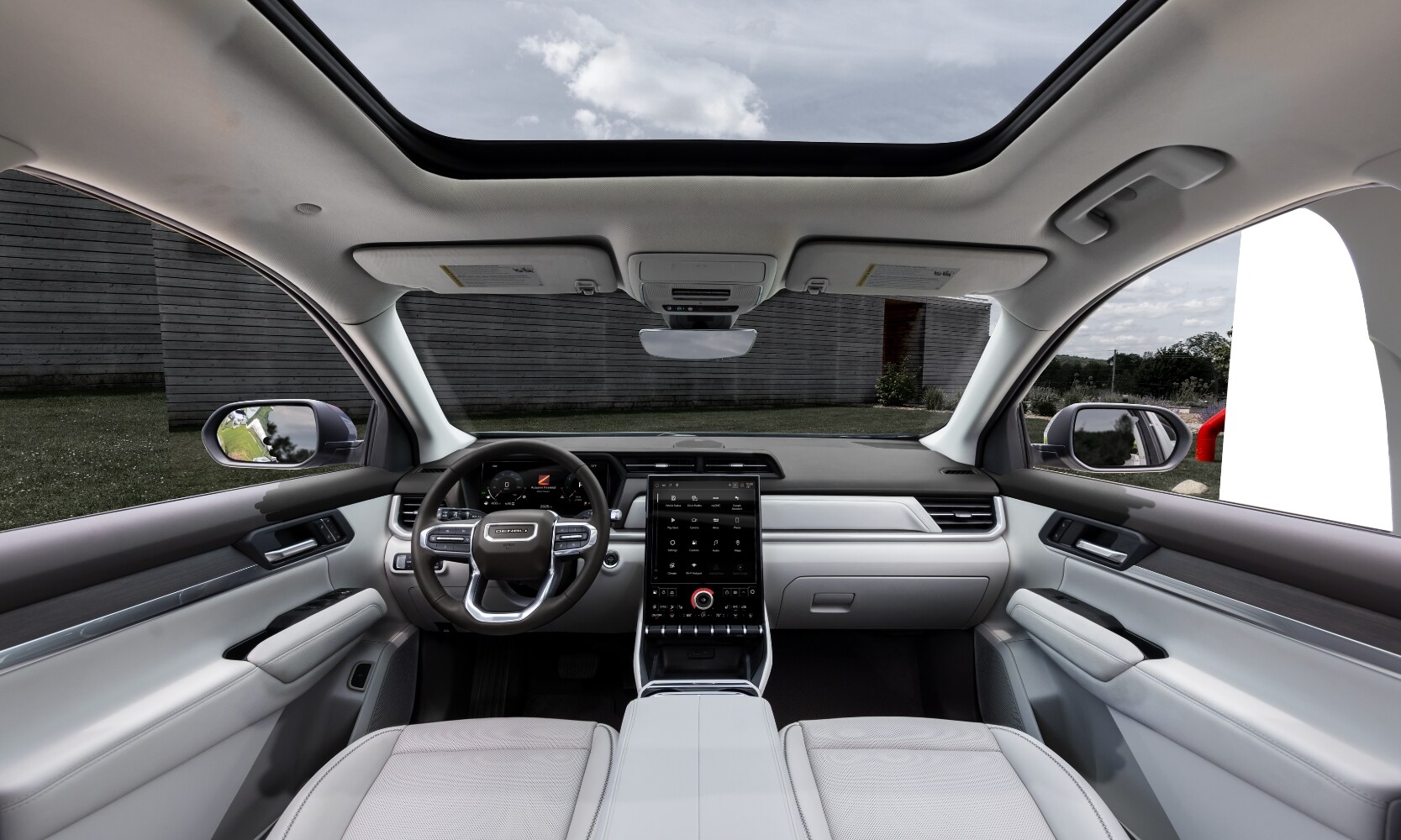 2026%20GMC%20Terrain%20Interior%20-%20Octane%20GMC%20of%20Santa%20Fe.jpg Interior image of a 2026 GMC Terrain Denali white front seat area, steering wheel, infotainment screen, and panoramic sunroof