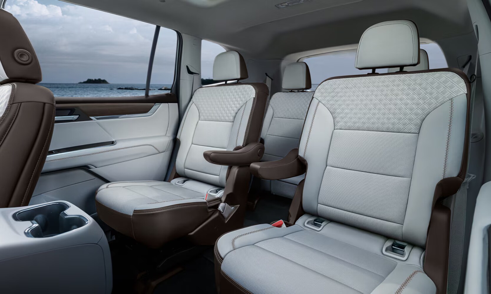 2026%20GMC%20Acadia%20Seating%20%20Octane%20GMC%20of%20Santa%20Fe.png Interior image of a 2026 GMC Acadia Denali Ultimate three rows with white and tan leather seats and window coastal views