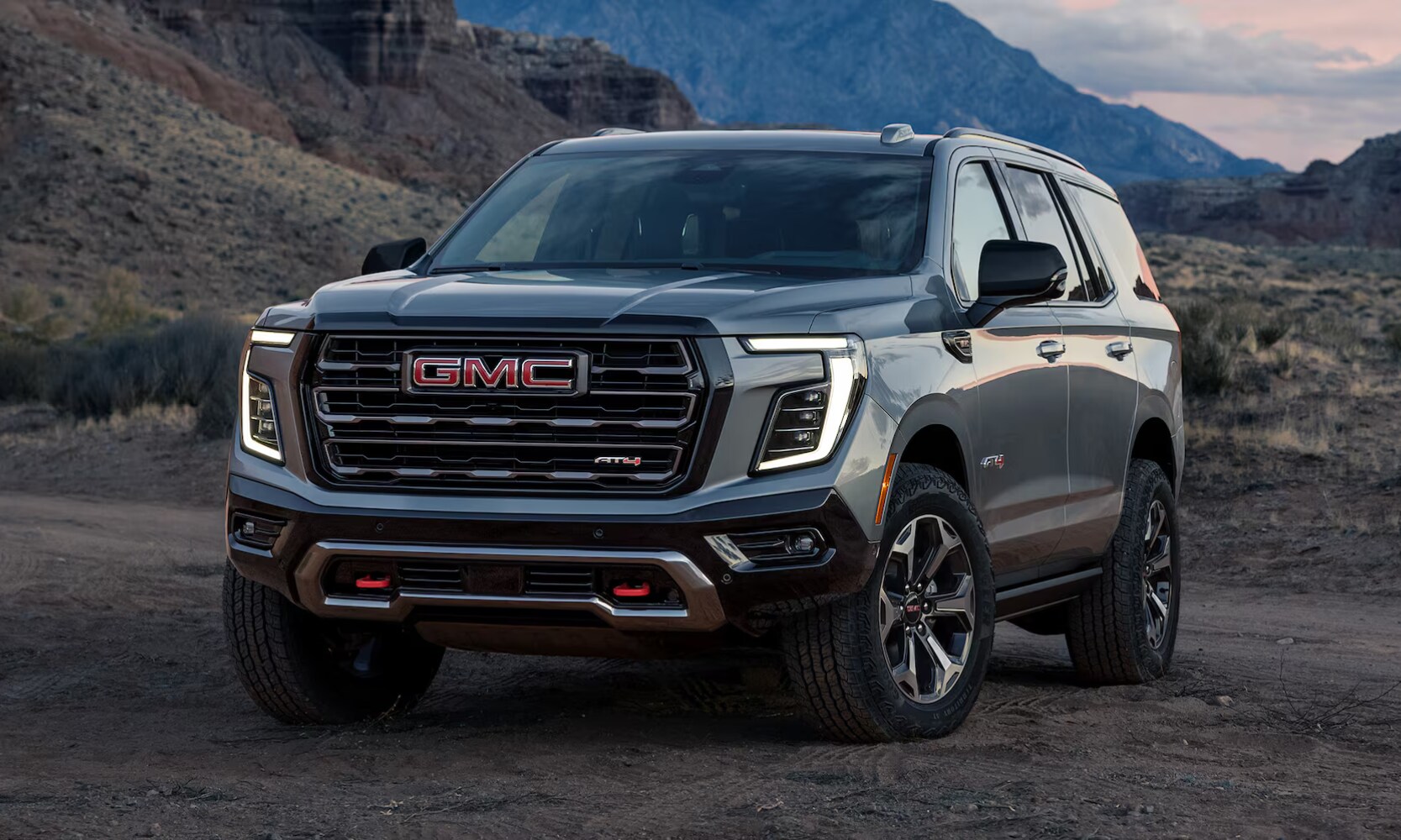 2026%20GMC%20Yukon%20AT4%20Ultimate%20-%20Octane%20GMC%20of%20Santa%20Fe.png Exterior front image of a gray 2026 GMC Yukon AT4 Ultimate parked in a mountain setting