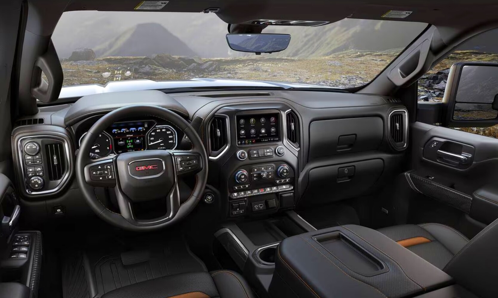photo of the 2020 GMC Sierra 2500 HD AT4 Truck's black and brown front seats with dashboard mountain views