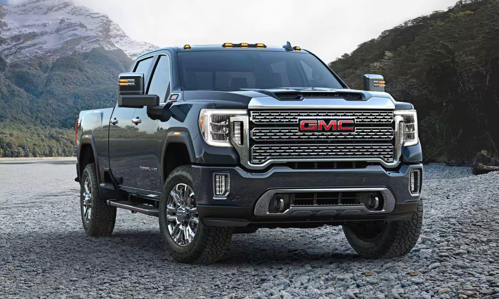 photo of a black 2020 GMC Sierra 2500 HD Denali Crew Cab in front of a mountain on a rocky road