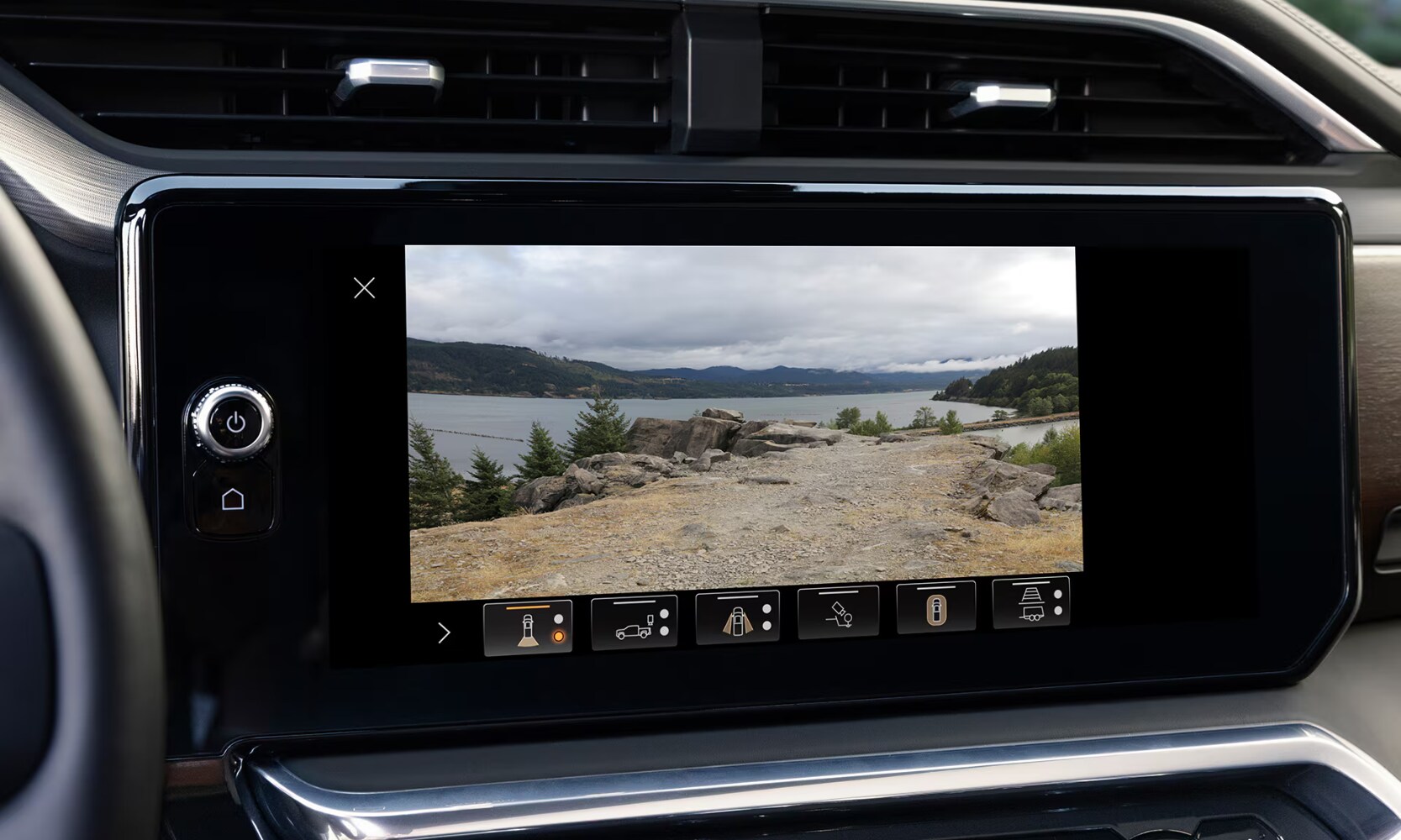 2026%20GMC%20Sierra%201500%20Safety%20Features%20-%20Octane%20GMC%20of%20Santa%20Fe.png Closeup image of the 2026 GMC Sierra 1500's camera system with rear truck lakeside views on its dashboard