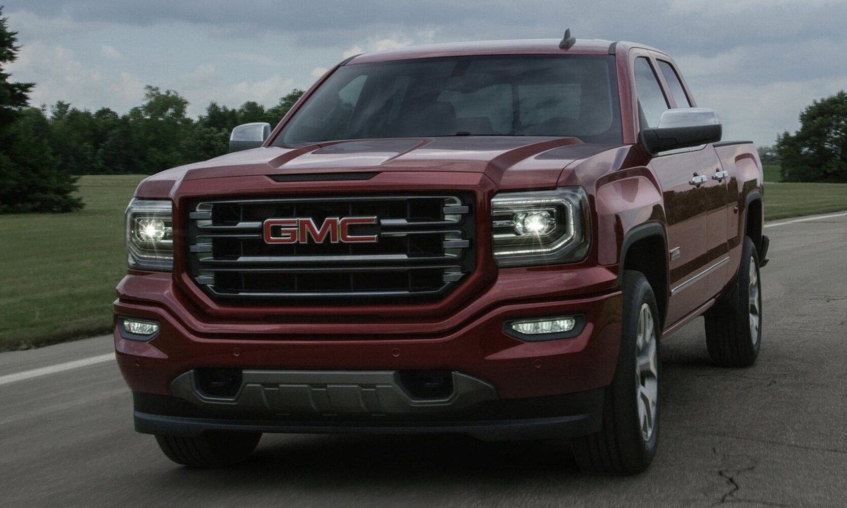 Used%202017%20GMC%20Sierra%201500%20Truck%20-%20Octane%20GMC%20of%20Santa%20Fe.jpg Front exterior view of a used 2017 GMC Sierra 1500 truck driving down an open road