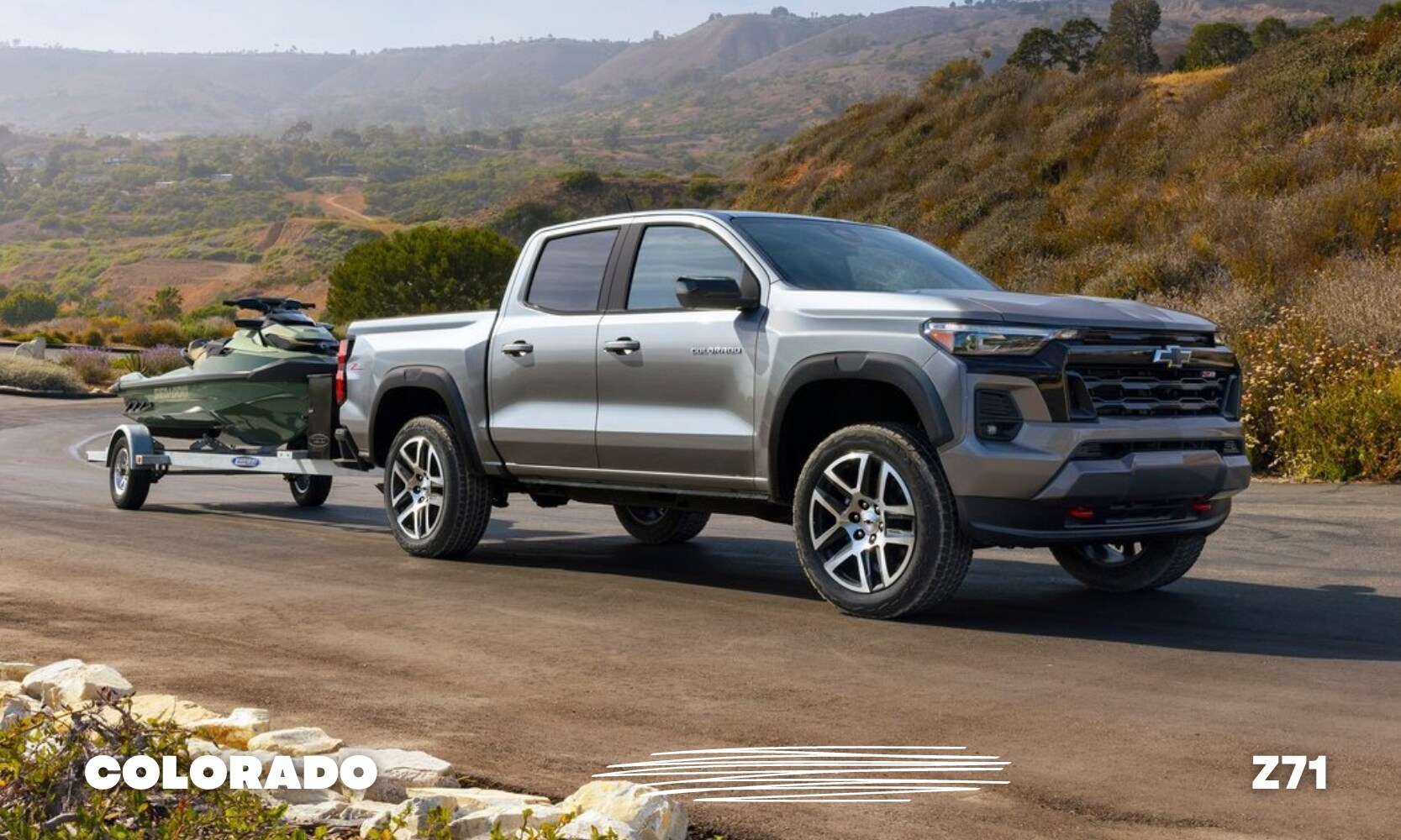 Best%20Used%20Chevy%20Colorado%20Z71%20Trucks%20-%20Octane%20GMC%20of%20Santa%20Fe.jpg a silver used Chevy Colorado Z71 truck towing a jet ski