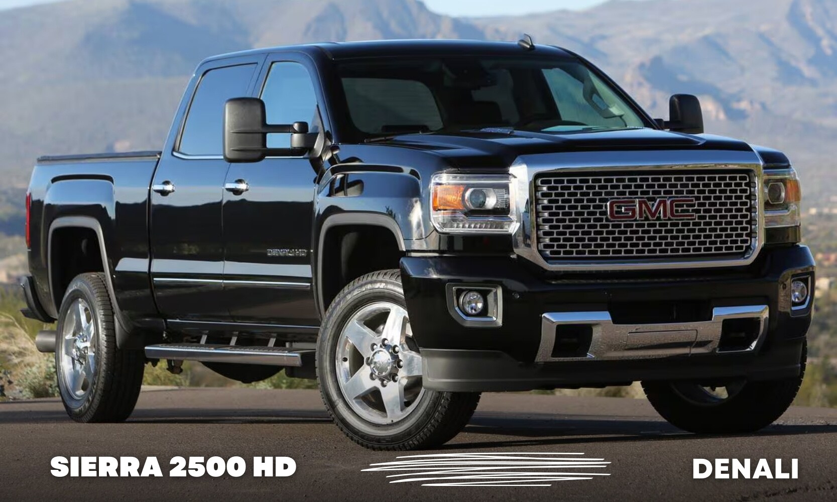 photo of a black 2016 GMC Sierra 2500 HD Truck Denali on a road with a mountain in the background