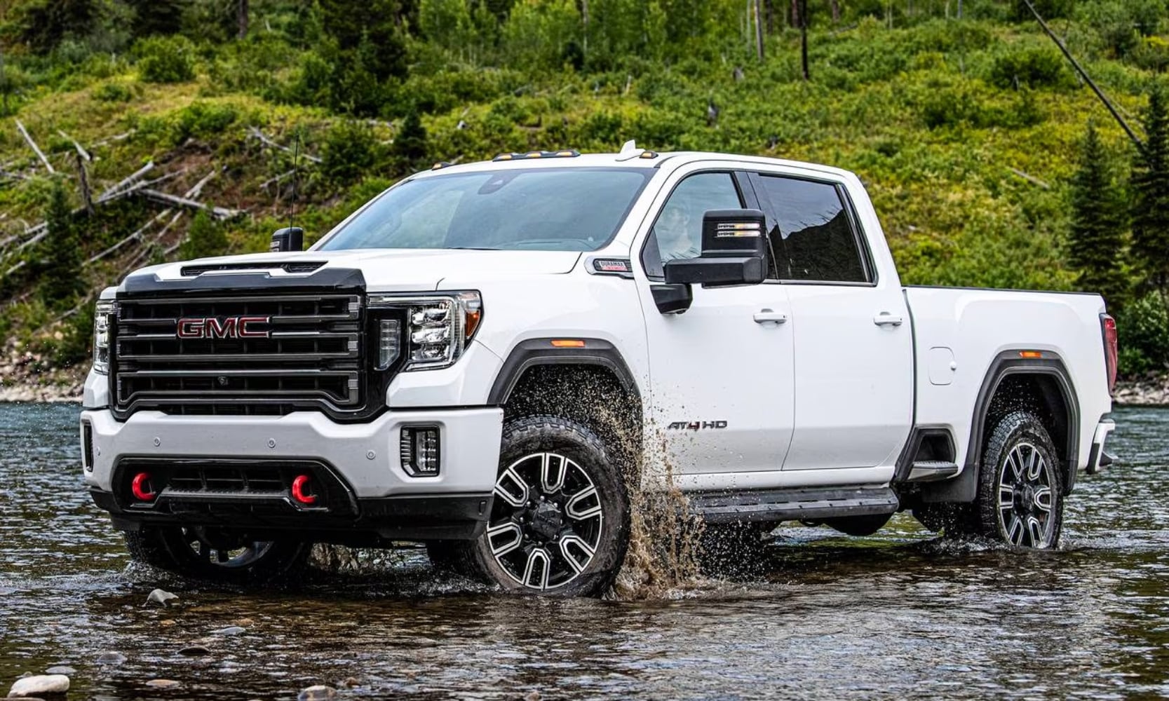 photo of a white 2020 GMC Sierra HD AT4 4x4 treading water in a rural landscape