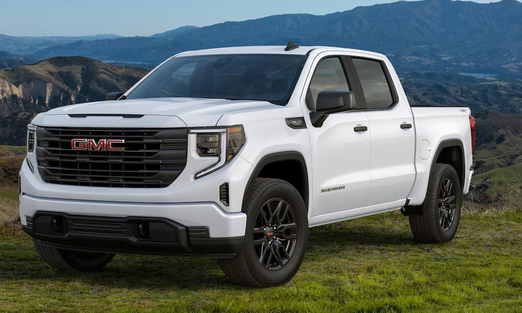 2026%20GMC%20Sierra%201500%20Pro-%20Octane%20GMC%20of%20Santa%20Fe.png Exterior front angle image of a white 2026 GMC Sierra 1500 Pro Graphite Edition parked on a grassy mountain