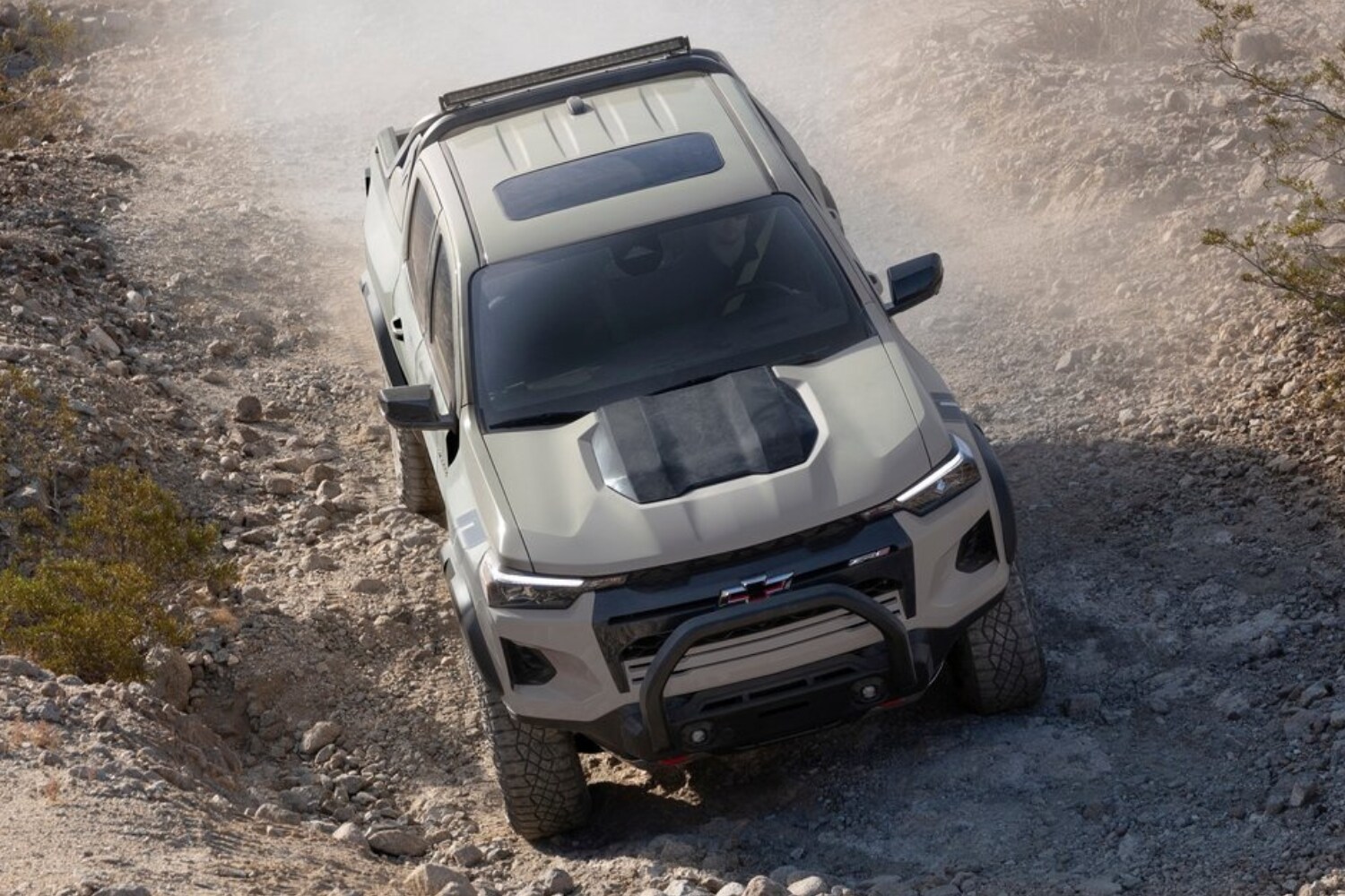 Aerial view of a 2023 Chevy Colorado ZR2 driving down hill on a rocky road