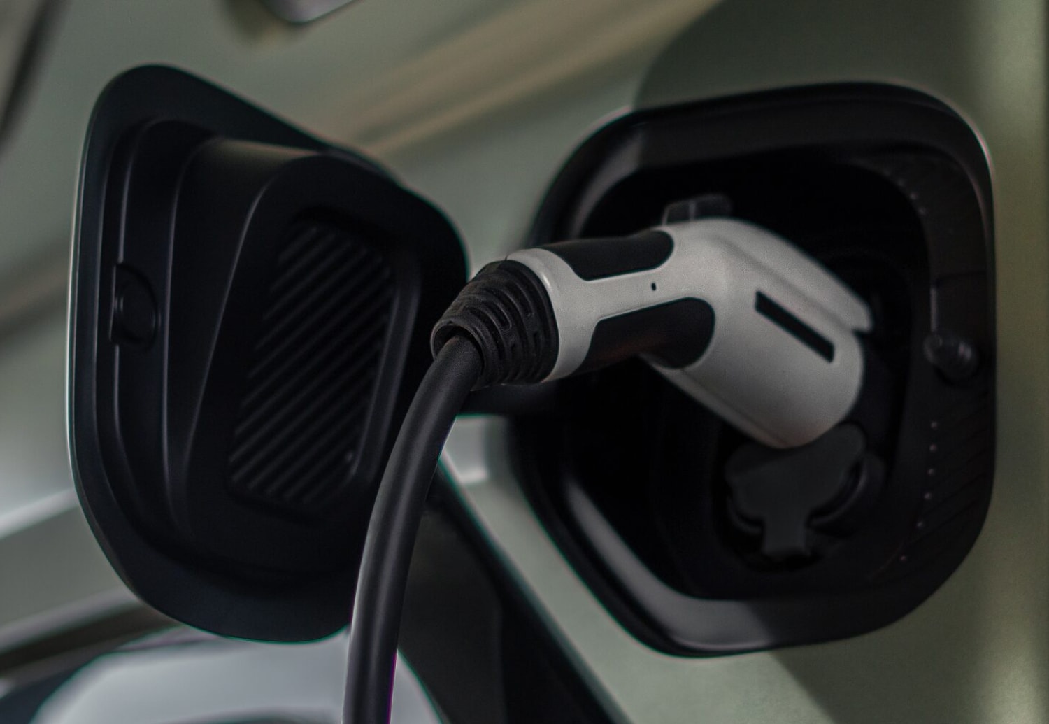 Close up view of a charging cable plugged into the 2024 GMC Hummer EV SUV