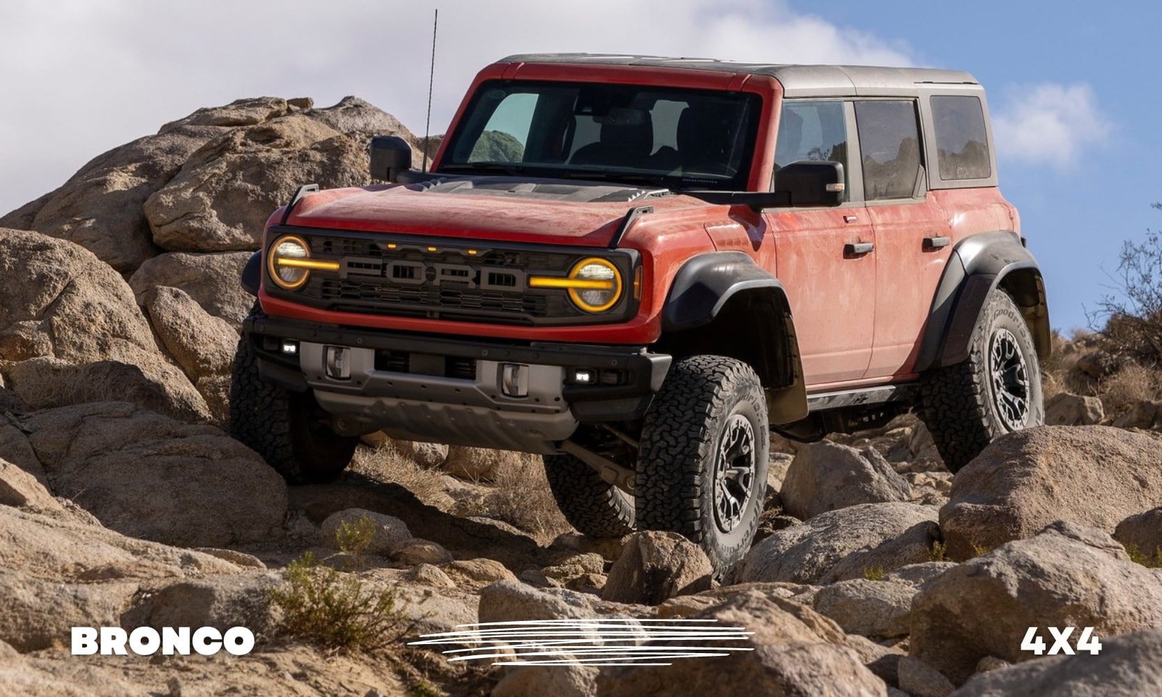 Front driver side view of a red Ford Bronco Raptor showing off its rock climbing prowess