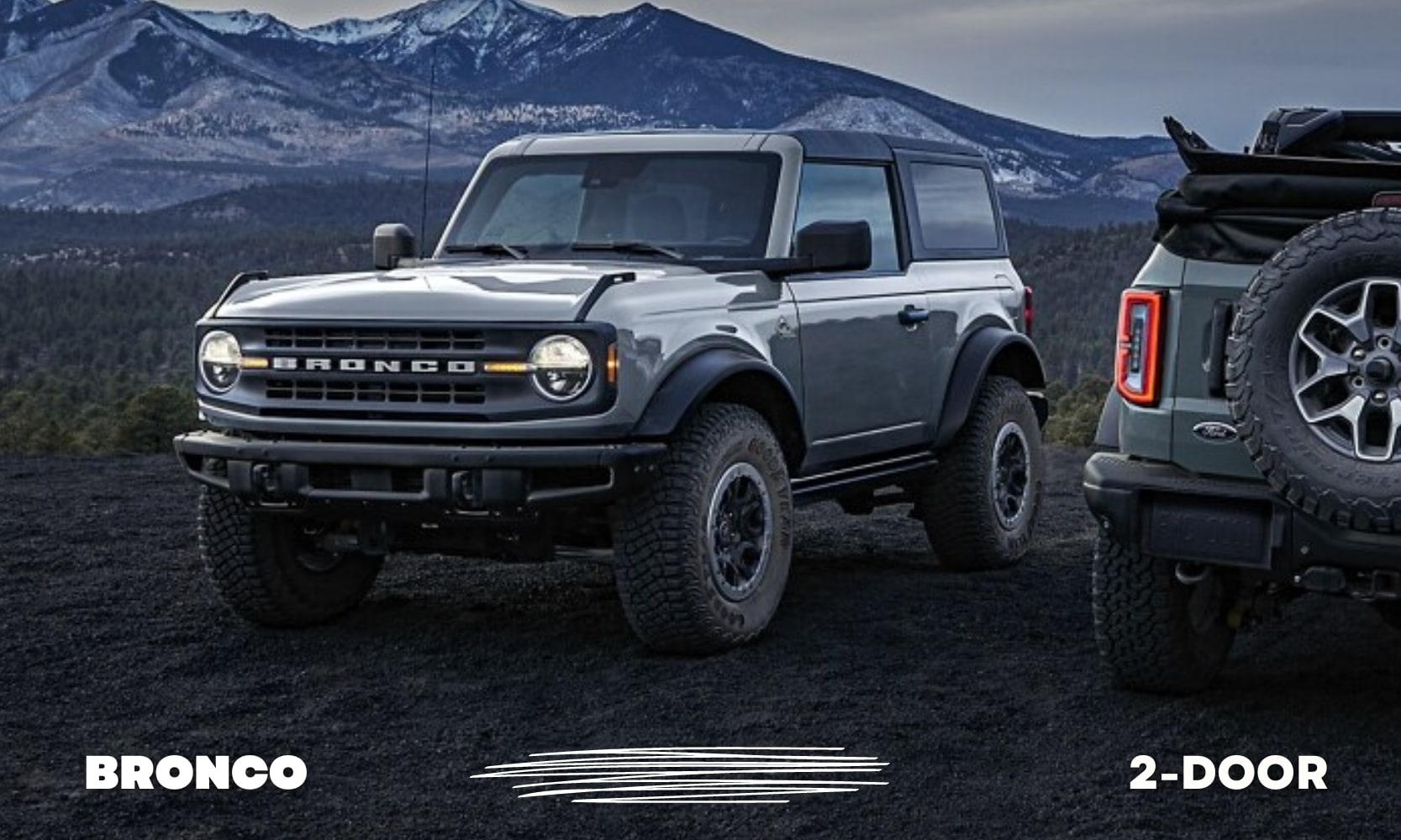 Front driver side view of a 2 door Ford Bronco parked on a hill top with snowy mountains in the background