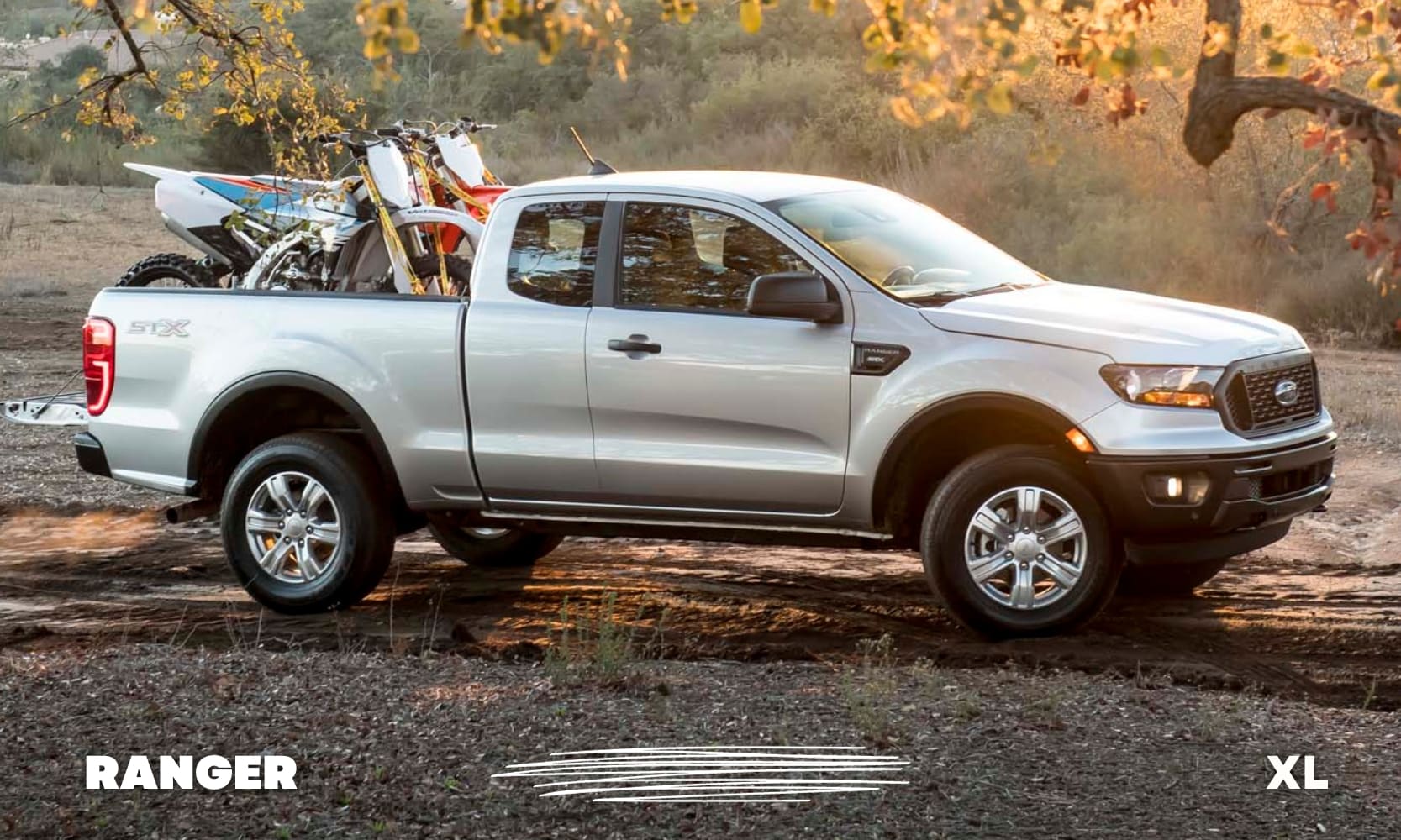 Passenger side exterior view of a Ford Ranger XL trim level with two dirtbikes loaded into the truck bed