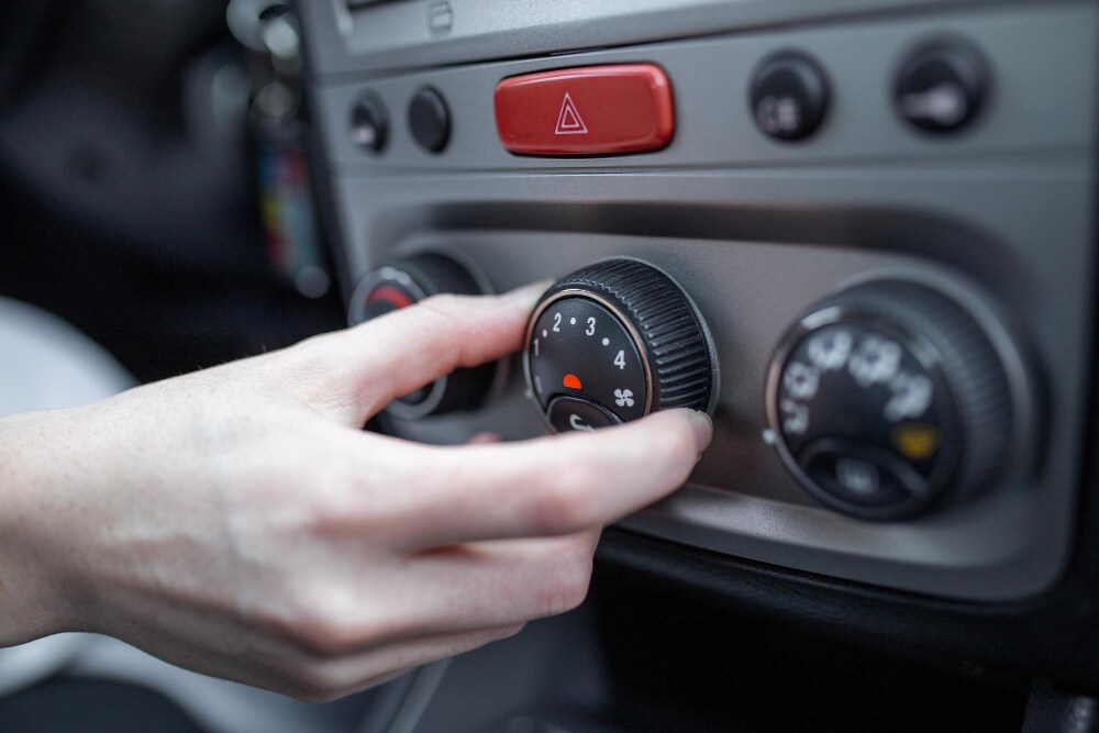 hand turning a/c car knob