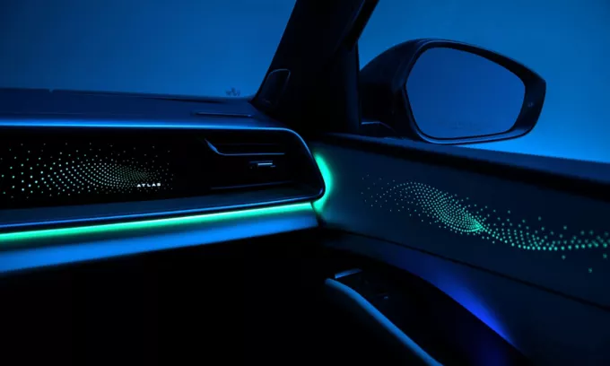 Available ambient lighting glowing across the dash and front passenger door of the 2027 Atlas
