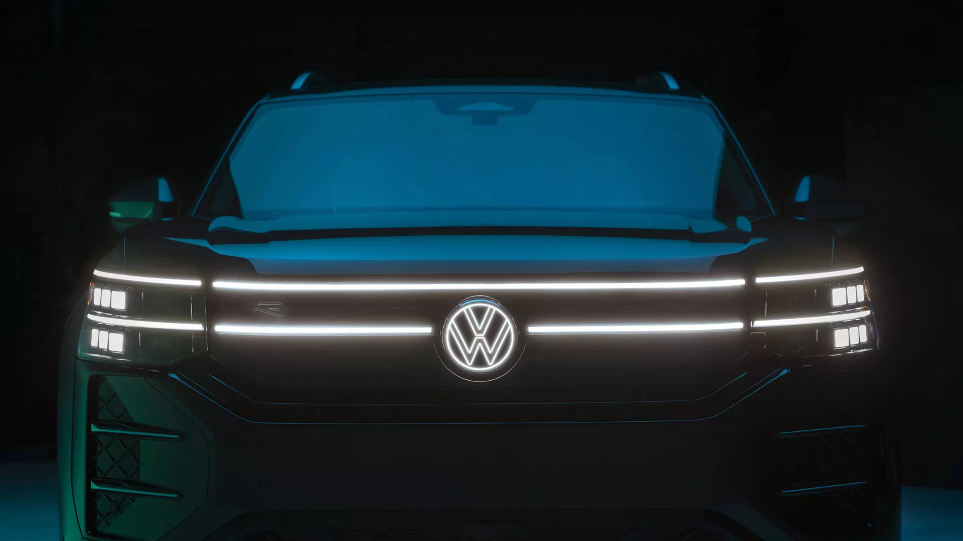 Close-up of the illuminated LED headlights and grille accents on the 2027 Atlas