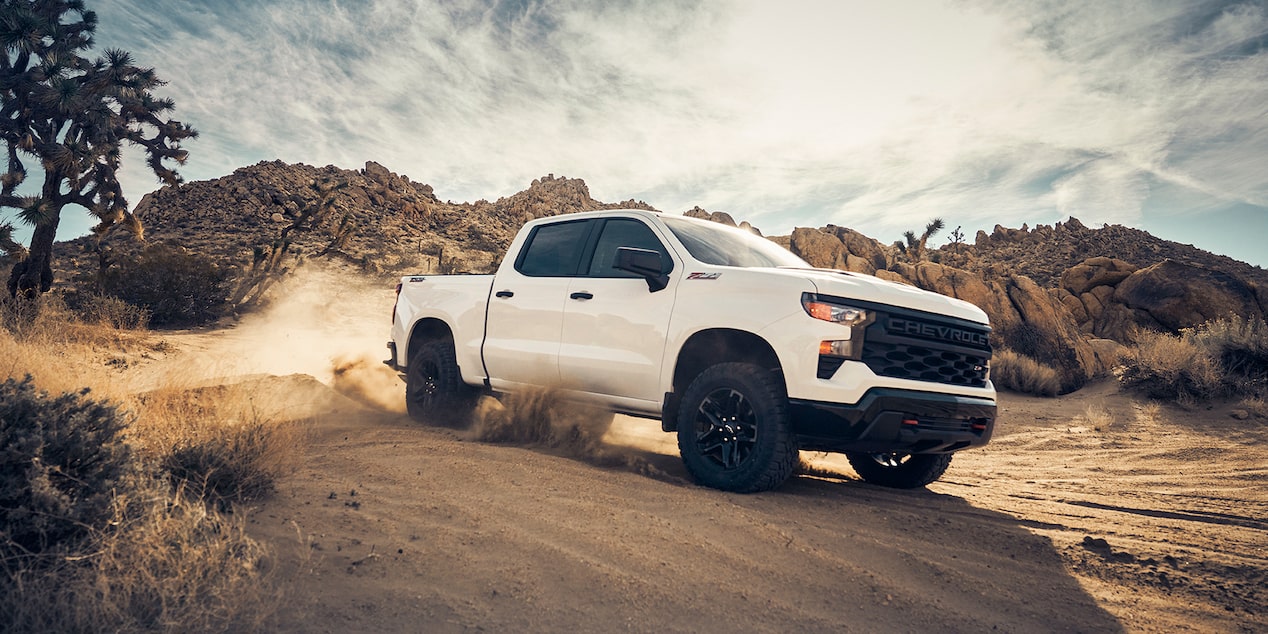 Front view of the 2023 Chevy Silverado 1500 in front of farm land