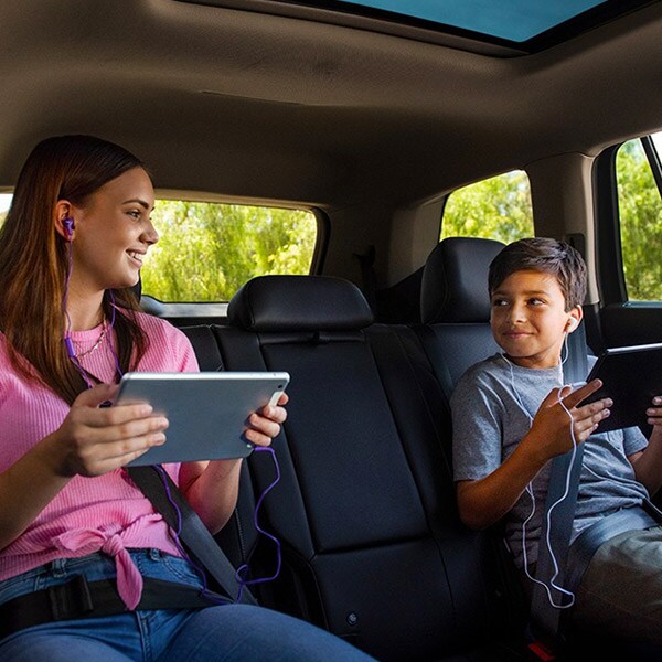 two kids connecting bluetooth streaming inside vw tiguan suv