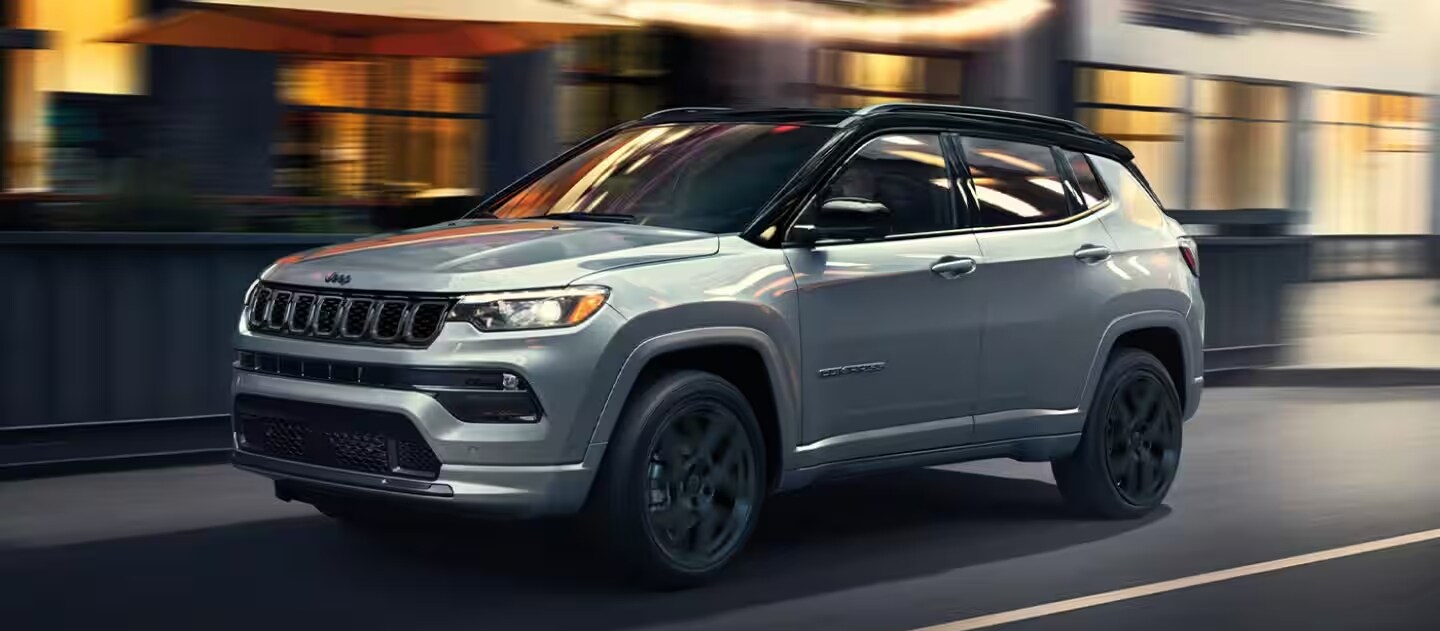 TITLE 2025 Jeep Compass with Blurred City Background