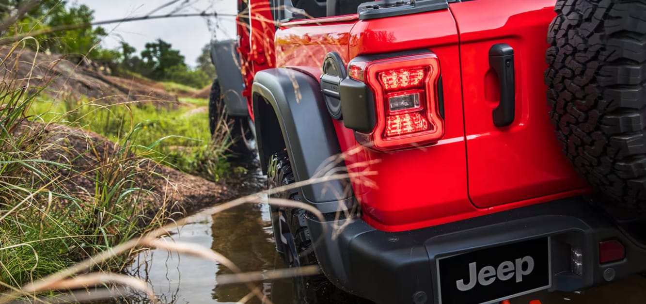 red jeep wrangler driving off road