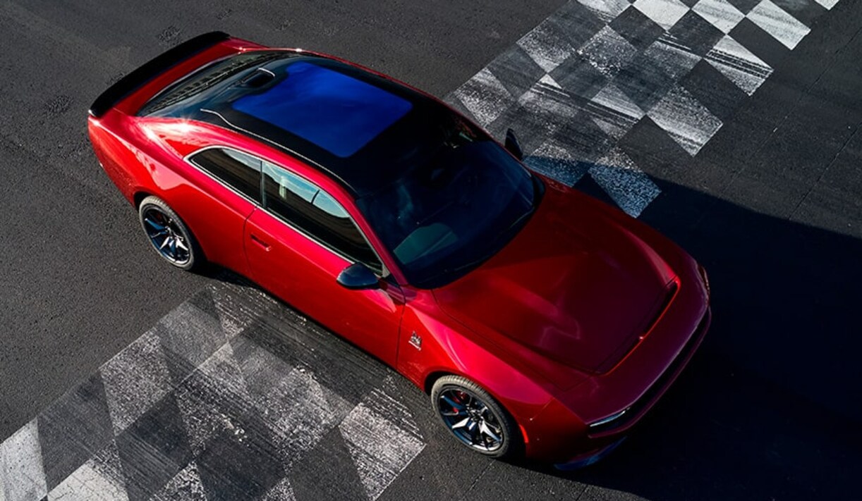 An overhead image of a red Dodge Charger crossing a finish line. An overhead image of a red Dodge Charger crossing a finish line.