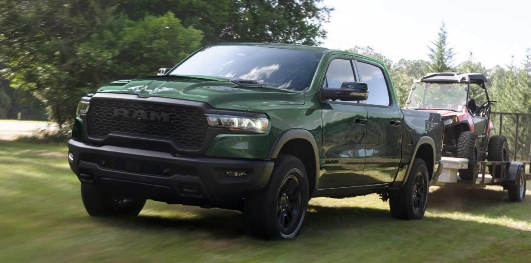 A green RAM 1500 towing a red golf cart over a grassy field.