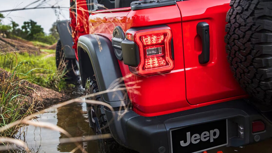 red jeep wrangler driving off road