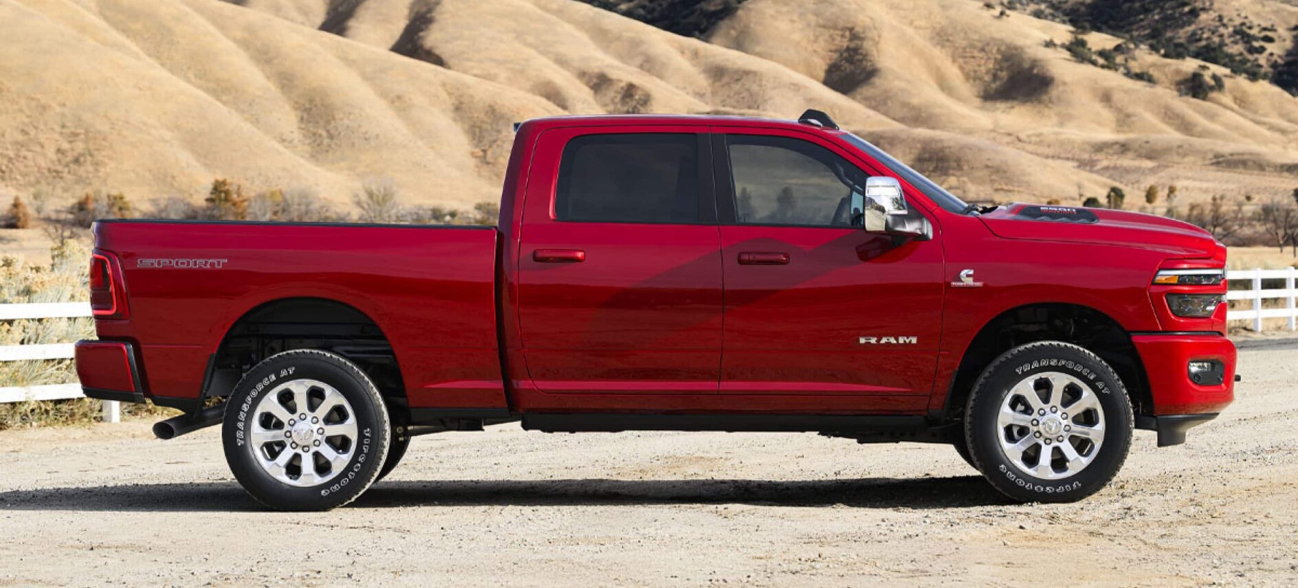 A side view of a red RAM 2500 on a ranch. A side view of a red RAM 2500 on a ranch.
