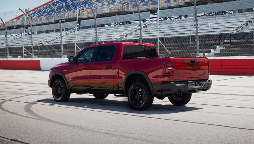 A red RAM 1500 driving on a race track.