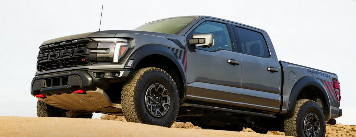 A gray Ford F-150 driving off-road through a desert.