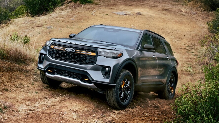 A blue-gray Ford Explorer driving off-road.