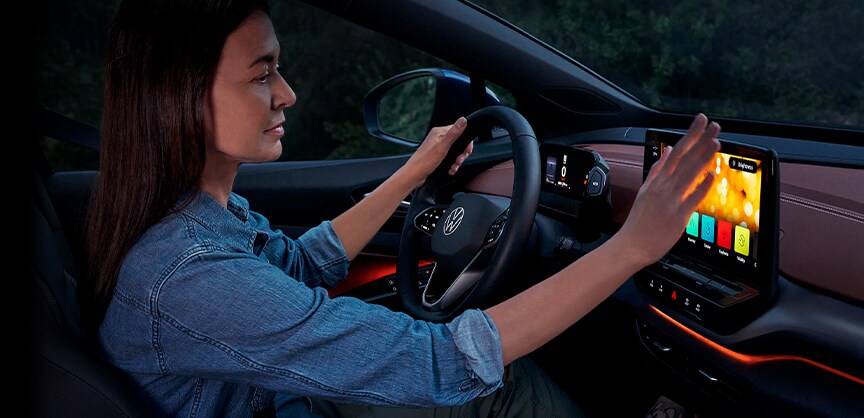 Performance features of the 2021 ID.4 at West Broad Volkswagen of Richmond |Woman driver using touch screen