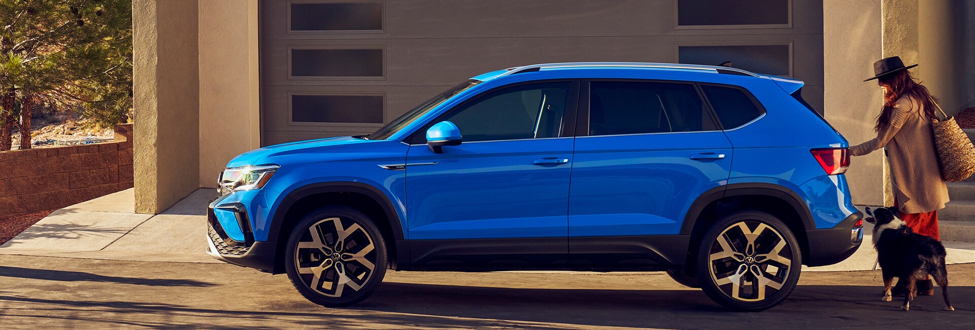 Performance features of the 2022 Taos at West Broad Volkswagen of Richmond | 2022 Taos sitting at modern home in sunlight