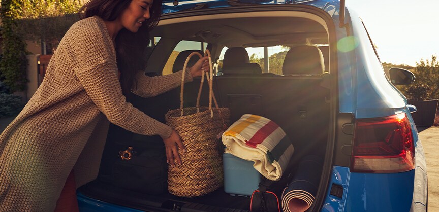 Performance features of the 2022 Taos at West Broad Volkswagen of Richmond | Woman using trunk space for personal items