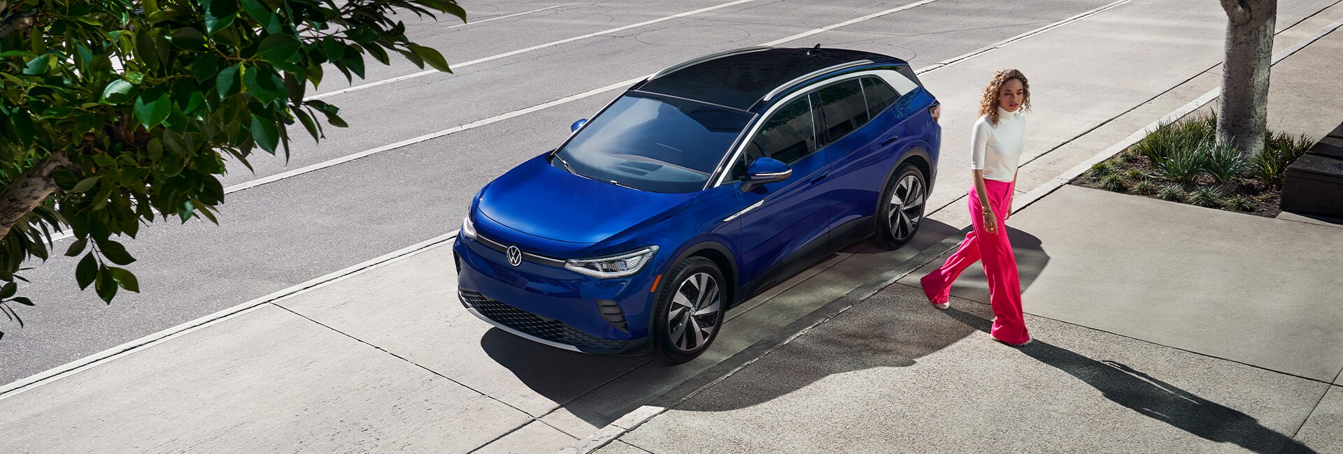 Performance features of the 2021 ID.4 at West Broad Volkswagen of Richmond |Woman walking away from parked 2021 ID 4 on city street